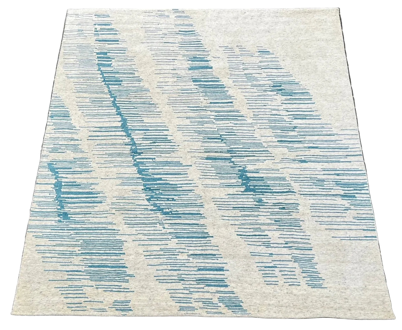 Textured rug with blue and gray pattern on a tiled floor